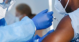 A healthcare worker administers the covid-19 vaccine to a patient.